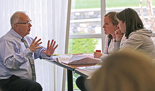 Presenter discussing with participants at a Wilson Workshop